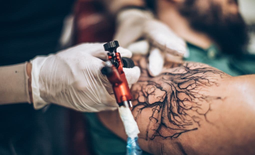 close up of tattoo needle on skin 